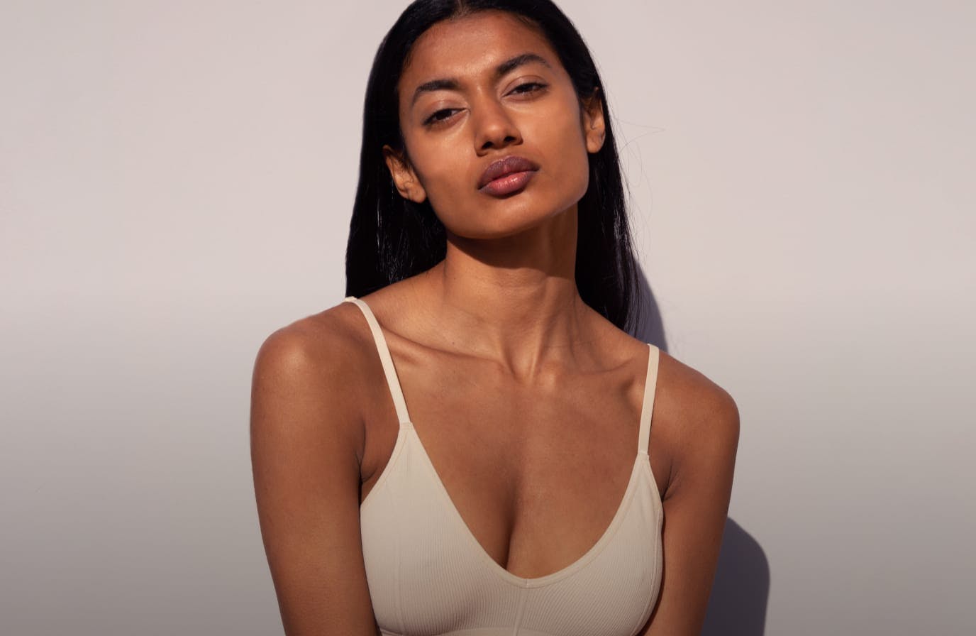 woman posing with tank top after breast augmentation