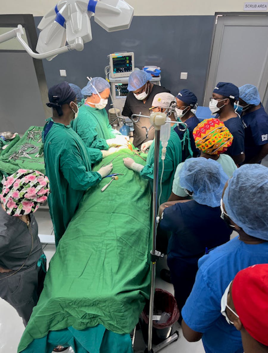 Doctors performing surgery circled around patient