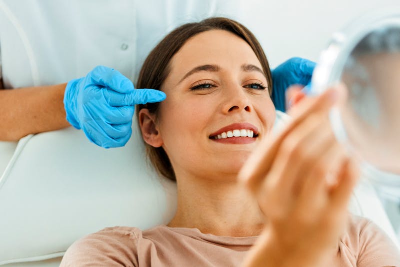 Doctor showing woman face in mirror